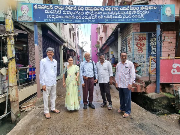 A small group standing outside the entrance to a learning centre.